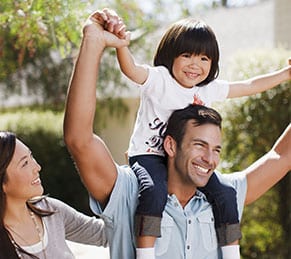 Mother, father and son with son on father's shoulders